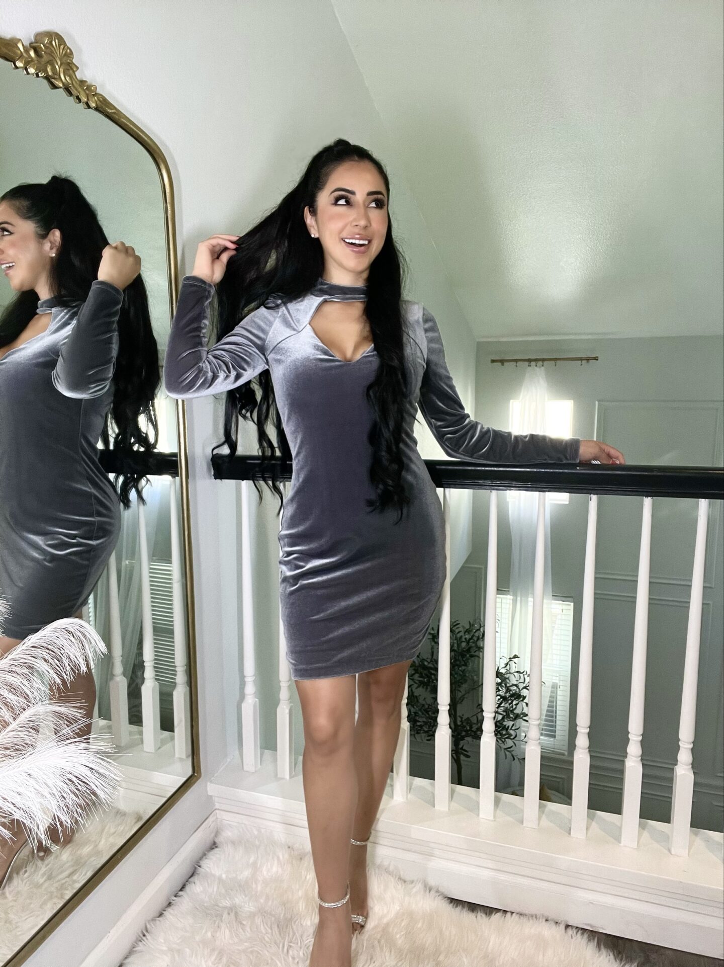 petite woman with long hair in grey cut out front bodycon dress
