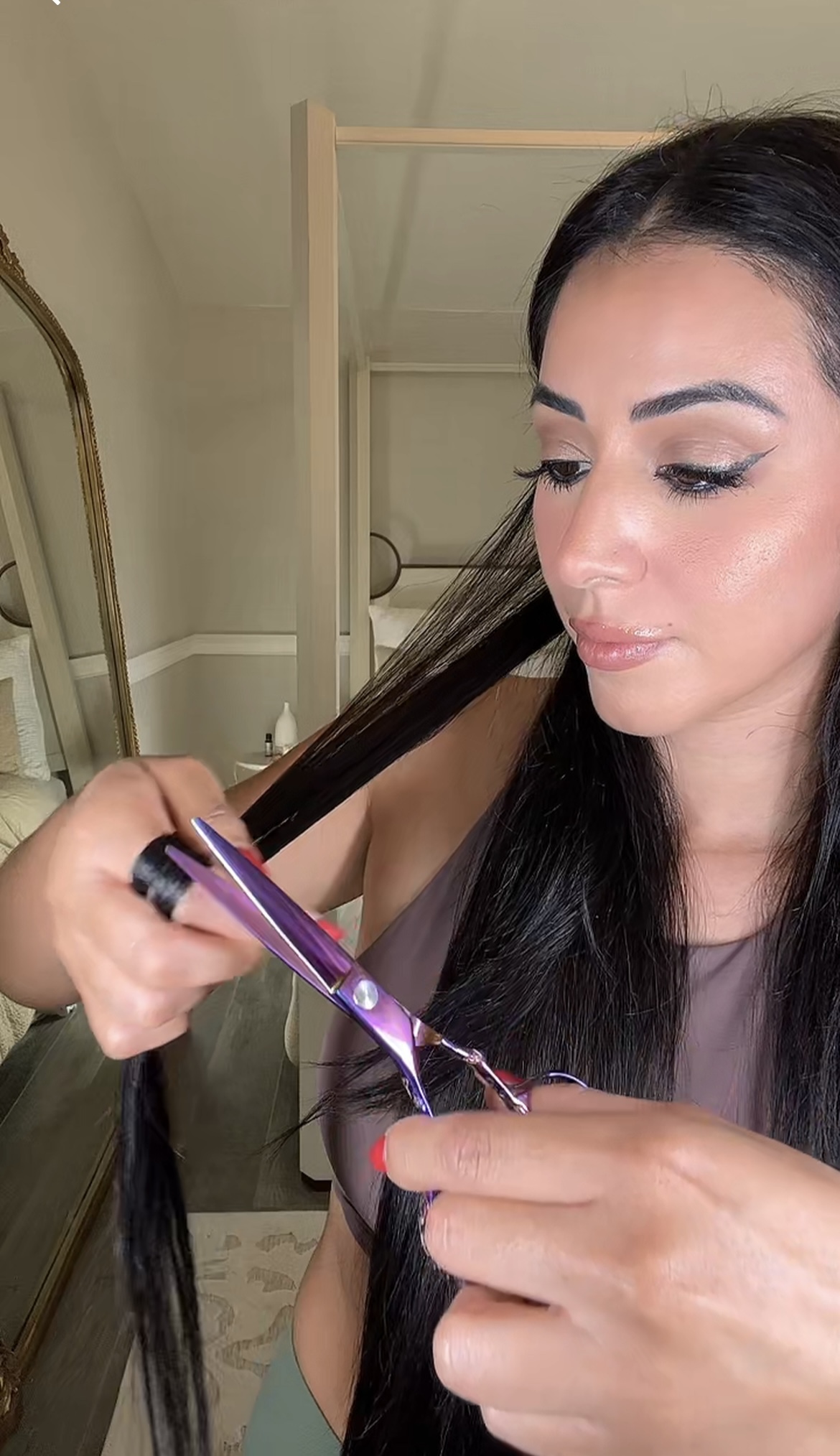 woman doing a hair dusting on her long hair