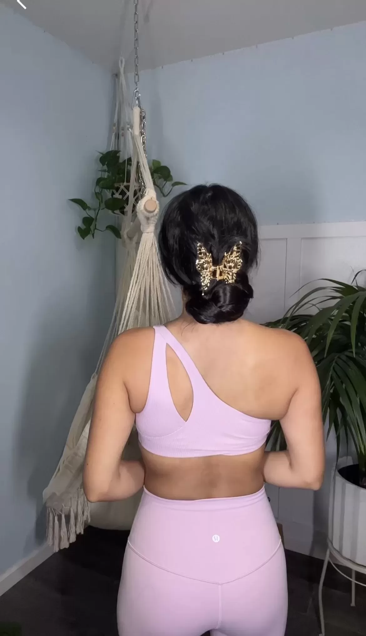 woman in pink peony lululemon set wearing a gold butterfly hair clip