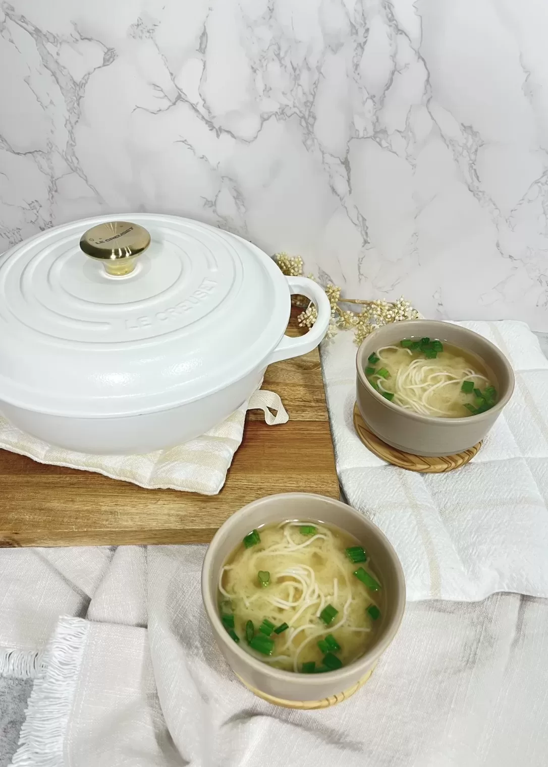 le creuset saucepan next to bowls of miso soup